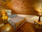 Open loft bedroom with a queen bed, flat screen tv and small private porch off the bedroom 